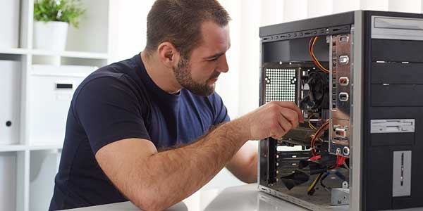 man taking apart a computer