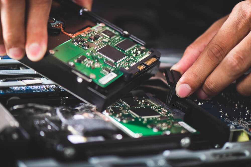 A hard drive being removed from a computer