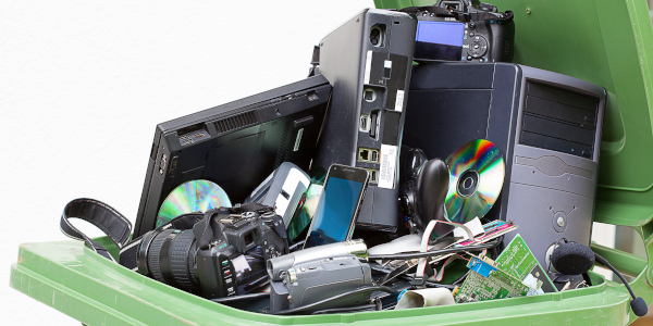 Electronics piled into a recycle bin