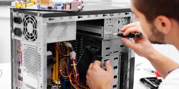 man taking apart a computer